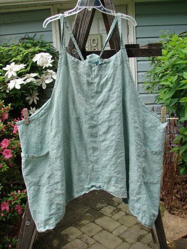 Barclay Linen Drop Pocket Apron Unpainted Seafoam Size 2 hanging on a clothesline. Features adjustable straps, drop sides, and double front pockets. Vintage Blue Fish Clothing from BlueFishFinder.com.