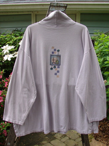 Barclay Philosophy Turtleneck Tunic featuring Epic Woman theme in Lavender, Size 3. Long-sleeved shirt with intricate design. Generous square shape, drop shoulders, and wider sleeves. Vintage Blue Fish Clothing from BlueFishFinder.com.