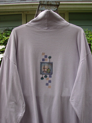 Barclay Philosophy Turtleneck Tunic Epic Woman Lavender Size 3: Grey sweatshirt with graphic design, featuring a semi-floppy ribbed turtleneck, drop shoulders, and wide sleeves. Vintage Blue Fish Clothing.