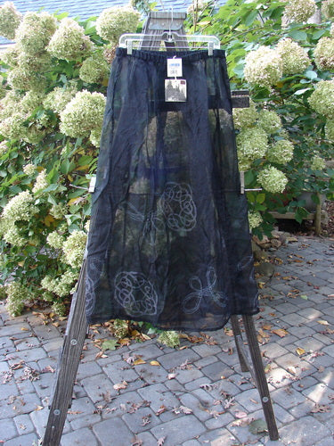2000 NWT Silk Organza Skirt, black, size 2. A floating, lined flare with a full elastic waistline and upper tie. Vertical exterior sectional panels. Lovely sheer plum hue. Celtic turn paint adds grace and movement. Waist: 32, Hips: 56, Sweep: 66, Length: 40.