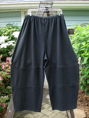 Vintage Barclay Interlock Moor's Pant in Black, Size 2, hanging on a clothesline. Features a full elastic waistband, unique pegged lower shape, and three sectional panels. Perfect for creative expression.