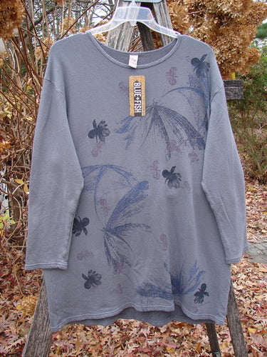 Barclay NWT Modal Organic Cotton Sketchbook Top Dragonfly Haze Size 1, featuring abstract motifs and a rounded neckline, displayed on a ladder, highlighting its loose fit and cozy sleeves.