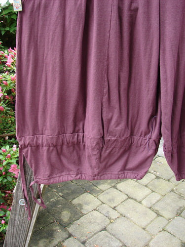 Barclay Tie Bottom Square Pant Unpainted Maroon Size 2 hanging on a fence, showcasing its wide lower legs and full elastic waistline with oversized pockets.
