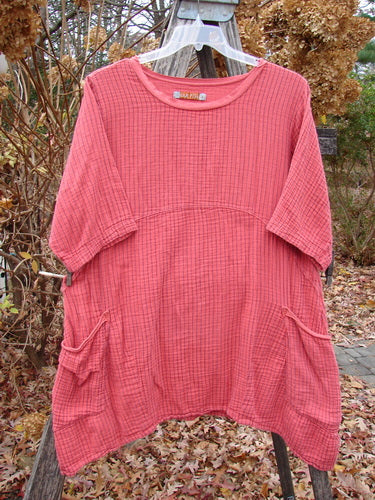 Barclay Gauze Two Pocket Urchin Dress Unpainted Geranium Stripe Size 1 features a loose fit, textured cotton, short sleeves, unique flutter neckline, and two front patch pockets, hanging outdoors over leaves.