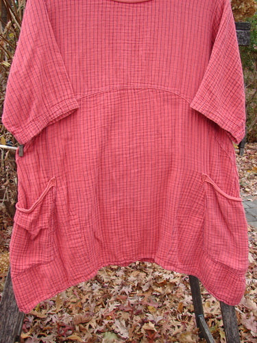 Barclay Gauze Two Pocket Urchin Dress Unpainted Geranium Stripe Size 1 features a loose-fitting tunic with 3/4 sleeves, empire seam, and hip flap pockets, beautifully displayed on autumn leaves.