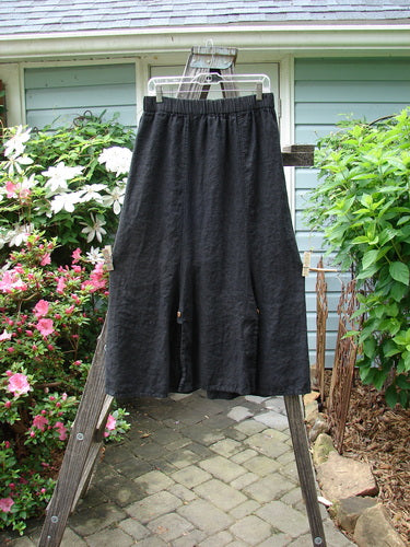 Black Barclay Linen Double Button Back Vent Skirt in perfect condition, hanging on a clothes rack, showcasing its mid-weight linen fabric and unique front double button vents.