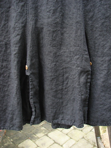 Close-up of the Barclay Linen Double Button Back Vent Skirt Unpainted Black Size 2, showcasing the unique front double button vents and elastic waistline.