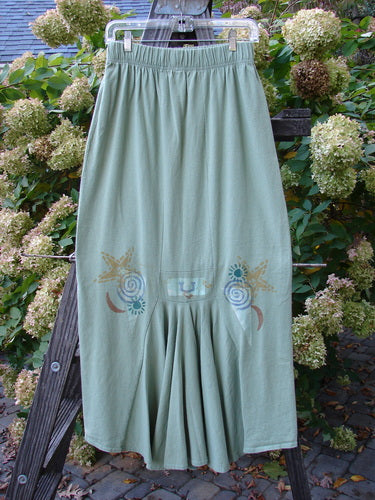 1995 Kick Pleat Skirt: Green skirt with a design on a rack. Features include a full elastic waist, widening shape, and a sassy rear kick pleat. Perfect condition.