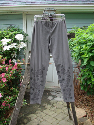 Barclay Cotton Lycra Legging Botanicals Grey Plum Size 2 displayed on a clothes rack, featuring a relaxed fit and floral design.