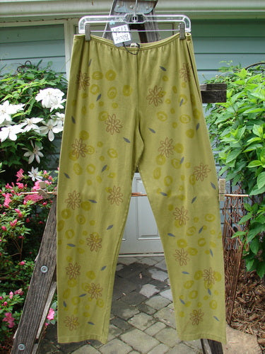A pair of Barclay NWT Cotton Lycra Legging in Leaf Flower Peapod Size 2 hanging on a clothesline, showcasing a relaxed fit and floral pattern.