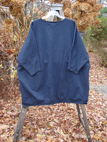 Barclay Cotton Lycra Flutter Hem Dolman Pullover Centered Ink OSFA displayed on a clear hanger, featuring a loose, oversized fit with dolman sleeves and a fluttered hem, capturing Bluefishfinder's creative, vintage style.