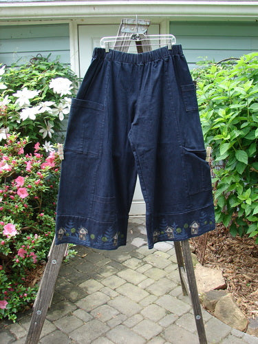 Barclay Heavy Weight Denim Crop Tool Pant Indigo Home Size 2 displayed hanging on a rack, showcasing its elastic waistline, exterior pockets, and paneled lower cuffs.