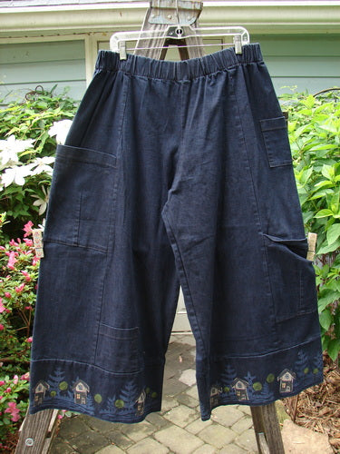 A pair of Barclay Heavy Weight Denim Crop Tool Pants in Indigo with multiple pockets, elastic waistline, and banded cuffs, showcasing a relaxed and functional design.