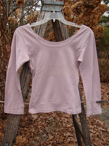 1994 Cotton Lycra Ballerina Layering Top Unpainted Plave Smaller Size 2, featuring a scoop neckline and quarter sleeves, hangs on a clear hanger against a rustic wooden ladder, embodying vintage Blue Fish charm.
