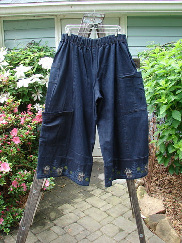 Alt text: Barclay Heavy Weight Denim Crop Tool Pant Indigo Home Size 2 hanging on a clothesline, showcasing its elastic waistline and multiple exterior pockets.