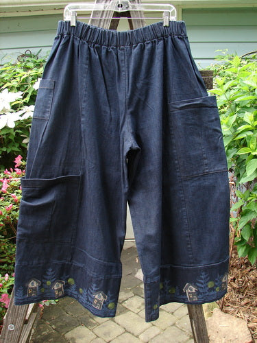 Alt text: Barclay Heavy Weight Denim Crop Tool Pant Indigo Home Size 2 with painted design, elastic waist, multiple pockets, and banded cuffs, showcased hanging.