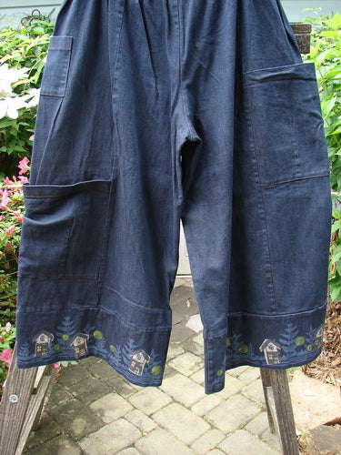 Barclay Heavy Weight Denim Crop Tool Pant Indigo Home Size 2 featuring multiple pockets, elastic waistline, cropped lowers, and pleated pocket bottoms, displayed outdoors against a wooden fence background.