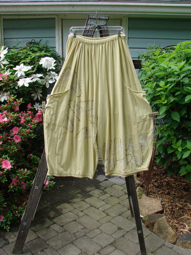 Barclay Hemstitch 4 Square Side Pocket Pant Pathway Plantain Size 2 displayed on a clothes rack, showcasing its unique 3D diamond drape and exterior drop side pockets.