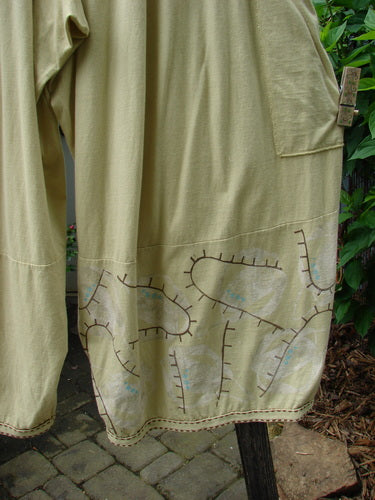 Close-up of the Barclay Hemstitch 4 Square Side Pocket Pant Pathway Plantain Size 2, showcasing the unique 3D diamond drape, exterior drop side pockets, and hemstitch lower detail.