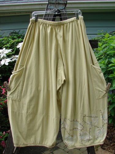 Barclay Hemstitch 4 Square Side Pocket Pant Pathway Plantain Size 2, displayed on a clothes rack, featuring unique 3D diamond drape from knee down and exterior drop side pockets.