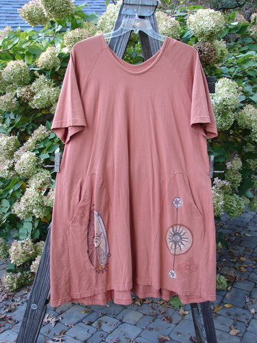 Image alt text: "1998 4 Elements Tress Dress Starburst Arausio Size 2: A pink shirt with a design on it, featuring a sweet A-line shape, side entry front pockets, and elongating skirt insets. Gently scooped neckline, smaller bust measurements, and Blue Fish Patch. Bust 52, Waist 60, Hips 62, Hem Circumference 80, Length 42."
