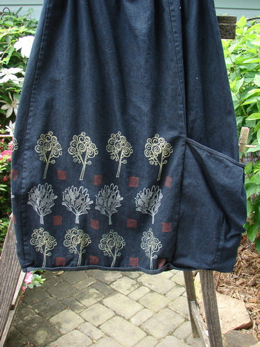 Barclay Heavy Weight Denim Belted Pocket Skirt Tree Black Indigo Size 2, featuring a full elastic waistline, oversized pocket, and vertical panels with forest-themed designs.