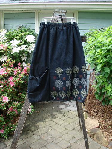 Barclay Heavy Weight Denim Belted Pocket Skirt Tree Black Indigo Size 2 displayed on a wooden ladder, showcasing its full elastic waistline, oversized wrap pocket, and sectional vertical panels.
