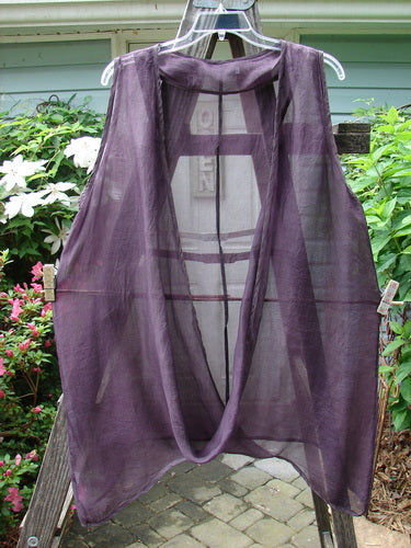 Barclay Silk Infinity Twist Pullover Unpainted Rich Plum Size 2 hanging on a clothesline, showcasing its unique open front with a lower twist and varying hemline.