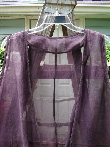 Barclay Silk Infinity Twist Pullover Unpainted Rich Plum Size 2 displayed on a hanger, showcasing its unique twist front, deeper arm openings, and varying hemline, suitable as an elegant outer layer.