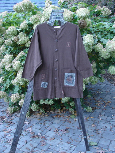 1996 Everyday Jacket Inner Woman Molasses Size 2: Brown jacket with patches, scribe buttons, oversized drop pockets, and Inner Woman theme paint.