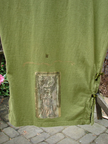 A vintage 1993 Tie Jumper featuring a Mythical Goddess theme in Olive, size 2. Detailed with Velvet Ribbon Ties, Empire Waist Seam, and Pegged Hem. From BlueFishFinder's collection of unique Blue Fish Clothing.