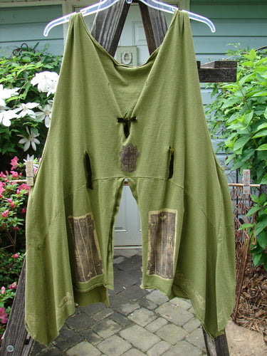 Vintage Blue Fish Clothing: 1993 Holy Vest Mythical Door Olive Size 2, green pants hanging on a clothesline outdoors, evoking creative freedom and individuality.