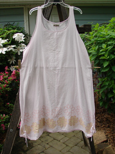 A white Barclay Batiste Round Neck Tie Up Shift Daisy Power Pink Cloud Size 2 hanging on a clothesline.