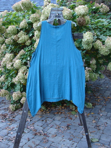 Barclay Crinkle Gauze Floral Contrast Pinafore Dress, a blue dress on a wooden rack. Scoop neckline, deeper arm opening, and full hem with a flattened floral print. Size 1, perfect condition.