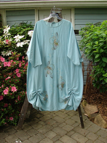 Barclay Hemp Cotton Silk Voile Belle Dress Wing Water Size 2 displayed on a hanger featuring a dramatic rear yoke backline with pleats, vertical rushing, and a unique wing and full moon theme.