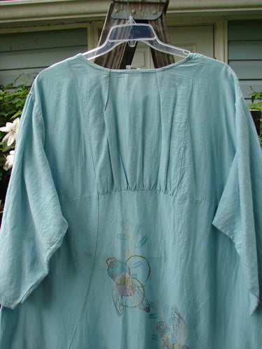 Barclay Hemp Cotton Silk Voile Belle Dress Wing Water Size 2 displayed on a hanger, showcasing its wide neckline, dramatic back yoke, and distinctive bell shape with pleats.