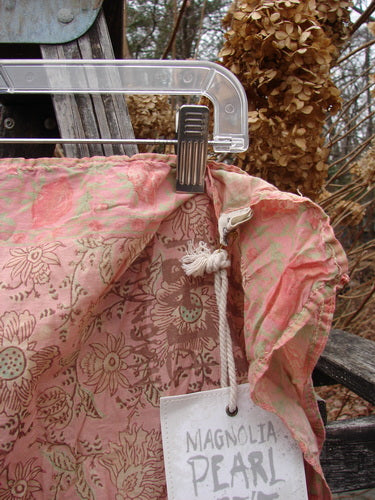 Magnolia Pearl NWT European Cotton MP Block Print Scarf Rosette, featuring a flowing, slightly sheer fabric with continuous floral patterns. Displayed on a hanger, the scarf embodies creative expression from Bluefishfinder.com.