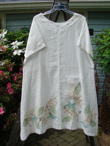 Barclay Linen Vertical Seam Pocket Dress Leaf Dove White Size 2, featuring a rounded neckline, wide short sleeves, and a single vertical seam, adorned with a bird pattern.