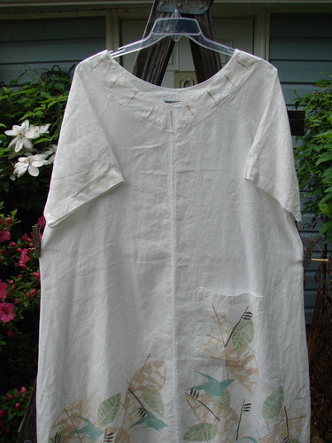 Alt text: Barclay Linen Vertical Seam Pocket Dress Leaf Dove White Size 2, featuring a rounded neckline, wide short sleeves, and a single vertical seam, displayed on a hanger.