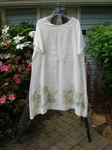 Barclay Linen Vertical Seam Pocket Dress Leaf Dove White Size 2 on clothes rack, featuring rounded neckline, wide short sleeves, exterior front pocket, and soft leaf and dove design.
