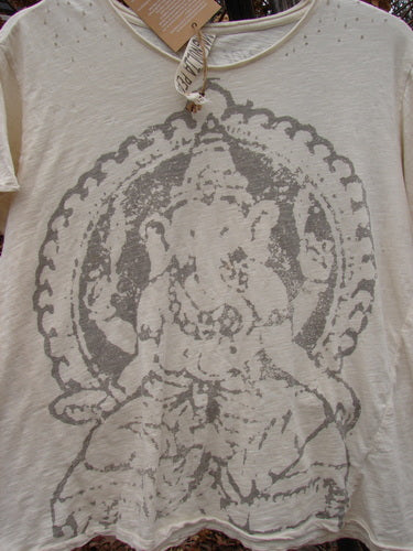 Magnolia Pearl NWT Cotton Jersey Boyfriend Tee Ganesh Moonlight OSFA features a faded gray Ganesha outline, decorative circular frame, rolled edges, diagonal wrap seam, and shoulder distressing, highlighting its unique vintage-inspired design.