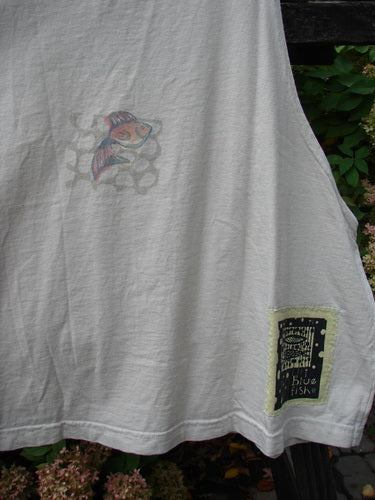 1999 Tank Top Goldfish Dust Size 2: A white shirt with a fish design on it, featuring a colorful goldfish theme paint and the signature Blue Fish patch. Perfect for hot summer days, this mid-weight organic cotton tank top has a wide, slightly longer boxy shape and a scooped neckline. Bust 56, Waist 60, Hips 64, Length 32 inches.