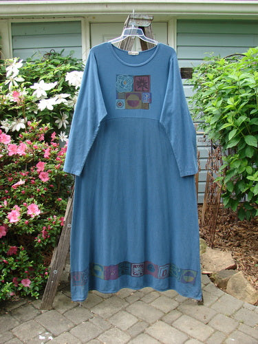 A Barclay Hemp Cotton Curved A Line Dress in Tealen Blue, size 2, displayed on a clothes rack, showcasing its vintage theme paint and extra-long length.