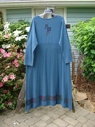 Barclay Hemp Cotton Curved A Line Dress Elements Tealen Blue Size 2 displayed on a clothes rack, showcasing its extra-long length, wide A-line shape, and downward curved empire waist seam.