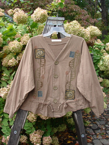 Image: A brown jacket with a design on it, featuring a double paneled V-neck, drawcord flounce, and original Blue Fish buttons. This Treehouse Jacket from the Fall 1997 Collection is made from Mid Weight Organic Cotton. Size 1.