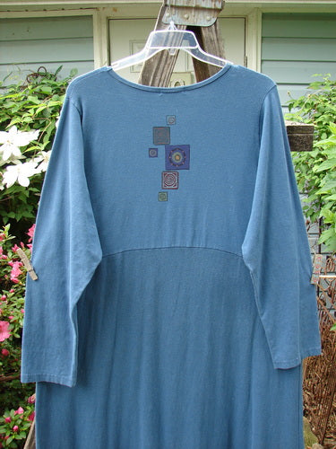 Alt text: Barclay Hemp Cotton Curved A Line Dress Elements Tealen Blue Size 2 with vintage-themed floral design, extra-long length, curved empire waist, and cozy sleeves.