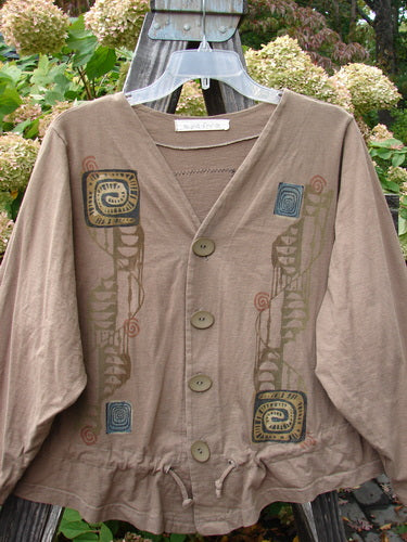 A 1997 Treehouse Jacket in Lumber, Size 1. Made from organic cotton, this jacket features a double paneled V neck, original Blue Fish buttons, and a drawcord flounce. The Primitive Climb theme paint adds a unique touch. Bust: 50, Waist: 58, Front Length: 26, Sleeves: 28, Back Length: 21.