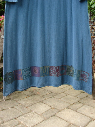 Barclay Hemp Cotton Curved A Line Dress Elements Tealen Blue Size 2 displayed on a brick surface, showcasing its wide A-line shape and downward curved empire waist seam.