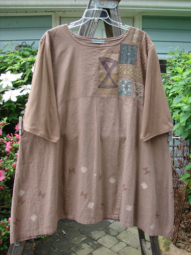 Barclay Cotton Sleeve Hemp Linen Sectional Dress Cobblestone Corner Mandorla Altered Size 2 displayed on a hanger, showcasing its patchwork design, three-quarter sleeves, and pleated A-line shape.