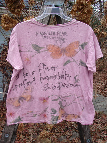 Magnolia Pearl NWT Cotton Jersey Boyfriend Tee Profound Responsibility Allium OSFA, featuring rolled edges, an Emily Dickinson quote, orange butterflies, and green leaves on the back, draped over a wooden ladder.